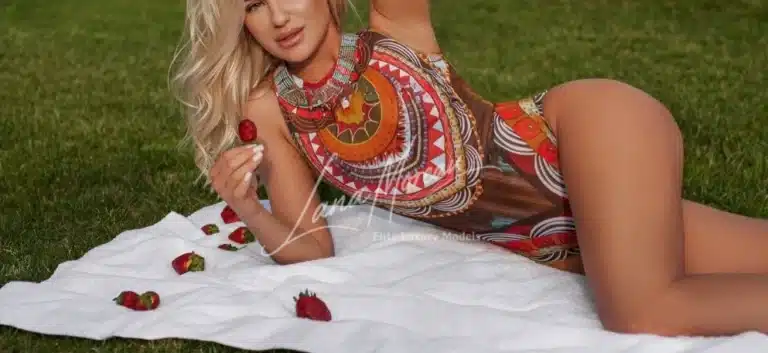 Luxury escort on hotel bed