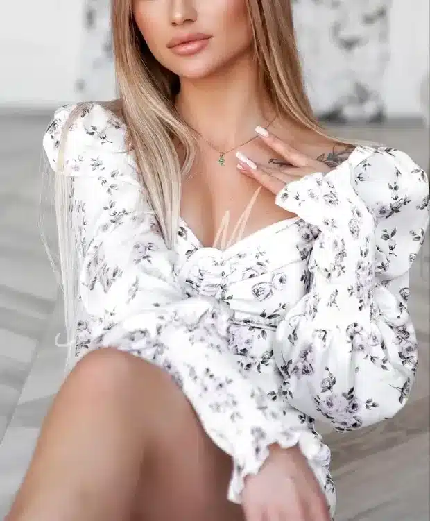 glamorous Dubai escort in white dress