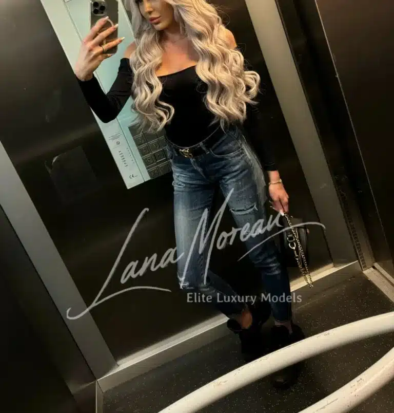 Blonde beauty in black top and jeans in elevator – casual luxury look