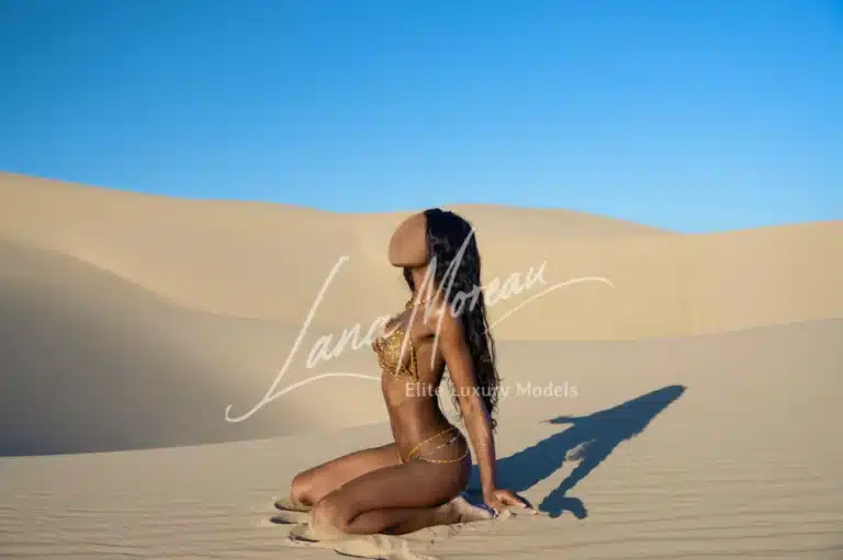 Sensual queen on sandy knees