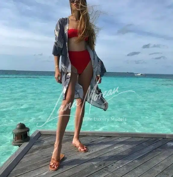 High Class Escort in bikini on tropical pier